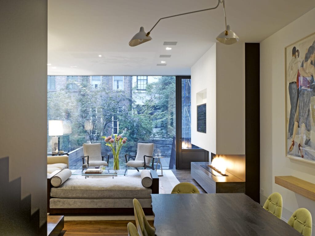 West Village NYC living room with large window looking out to backyard